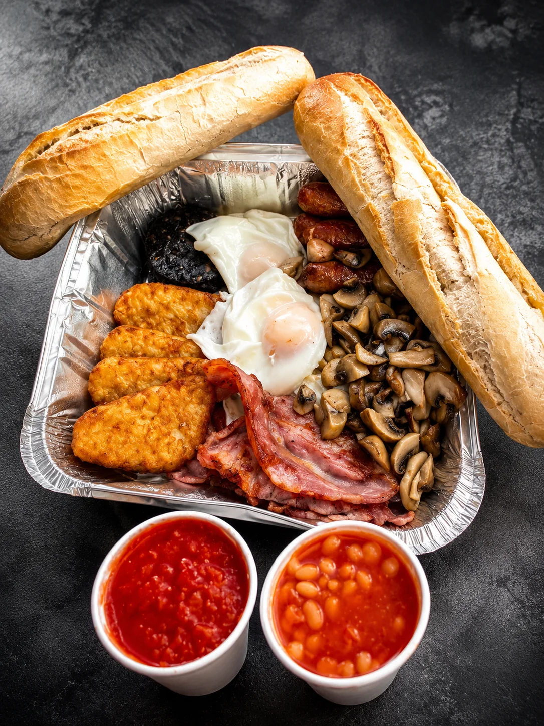A full breakfast with eggs, bacon, hash browns and mushrooms
